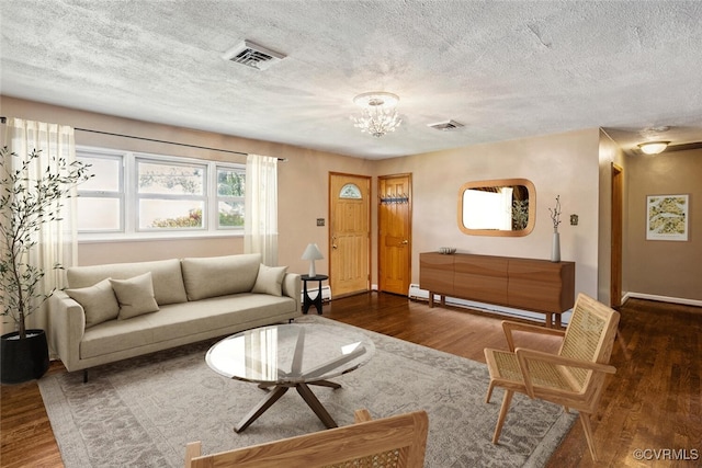 2407 Birchwood Rd, Henrico, VA 23294 - living room featuring wood finished floors, a chandelier, baseboard heating, a baseboard heating unit, and a textured ceiling