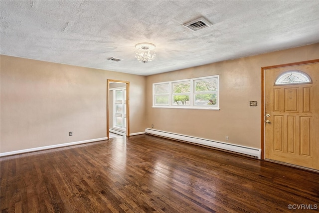 2407 Birchwood Rd, Henrico, VA 23294 - foyer featuring a baseboard heating unit, a chandelier, wood finished floors, plenty of natural light, and a textured ceiling