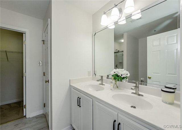 915 Jamerson Ln, Glen Allen, VA 23059 - full bathroom with double vanity, a spacious closet, wood finished floors, and a shower