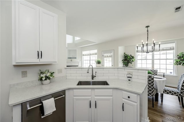915 Jamerson Ln, Glen Allen, VA 23059 - kitchen featuring stainless steel dishwasher, a peninsula, a chandelier, and white cabinetry
