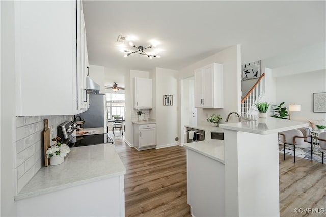 915 Jamerson Ln, Glen Allen, VA 23059 - kitchen with light wood-style floors, a peninsula, range with electric cooktop, freestanding refrigerator, and white cabinetry