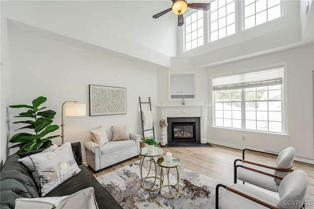 915 Jamerson Ln, Glen Allen, VA 23059 - living room with plenty of natural light, a ceiling fan, a high ceiling, light wood finished floors, and a fireplace with flush hearth