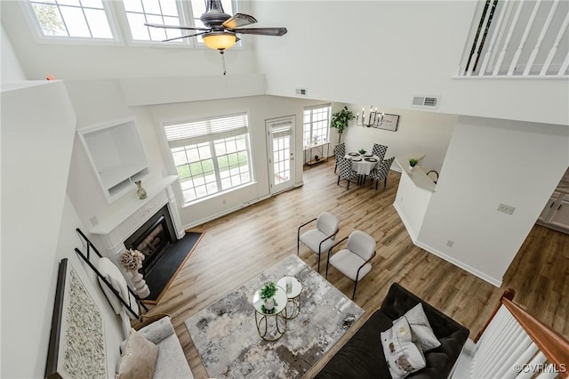 915 Jamerson Ln, Glen Allen, VA 23059 - living area featuring a towering ceiling, ceiling fan, a glass covered fireplace, and wood finished floors