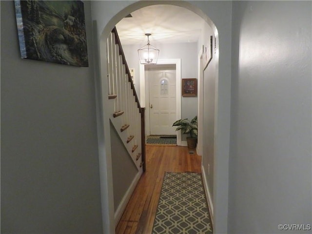 5900 River Rd, South Chesterfield, VA 23803 - hall featuring wood finished floors, stairway, a chandelier, and arched walkways