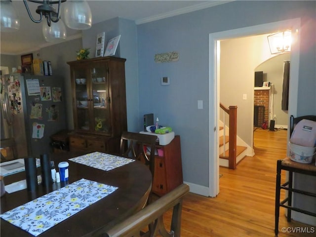 5900 River Rd, South Chesterfield, VA 23803 - dining room with crown molding, wood finished floors, stairs, and a chandelier