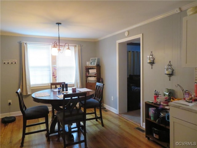 5900 River Rd, South Chesterfield, VA 23803 - dining space with crown molding, wood finished floors, and a chandelier