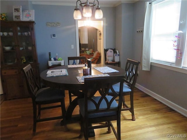 5900 River Rd, South Chesterfield, VA 23803 - dining area with arched walkways, light wood finished floors, ornamental molding, and a chandelier