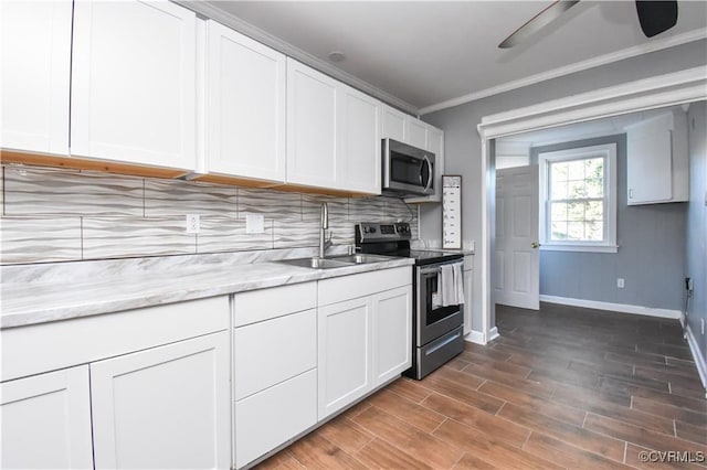 5900 River Rd, South Chesterfield, VA 23803 - kitchen with appliances with stainless steel finishes, tasteful backsplash, white cabinetry, ceiling fan, and ornamental molding