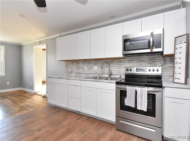 5900 River Rd, South Chesterfield, VA 23803 - kitchen featuring stainless steel appliances, light countertops, ornamental molding, white cabinetry, and backsplash