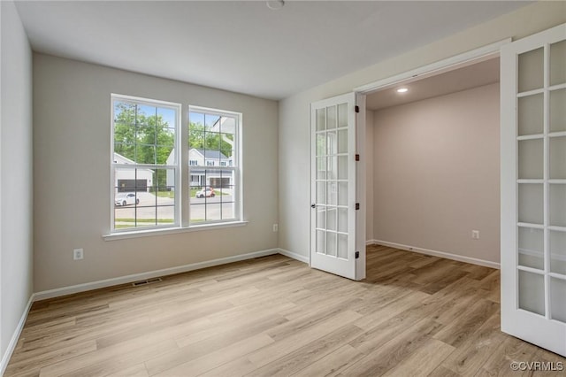 7127 Braxton Ct, Ladysmith, VA 22546 - spare room with french doors, light wood finished floors, and recessed lighting