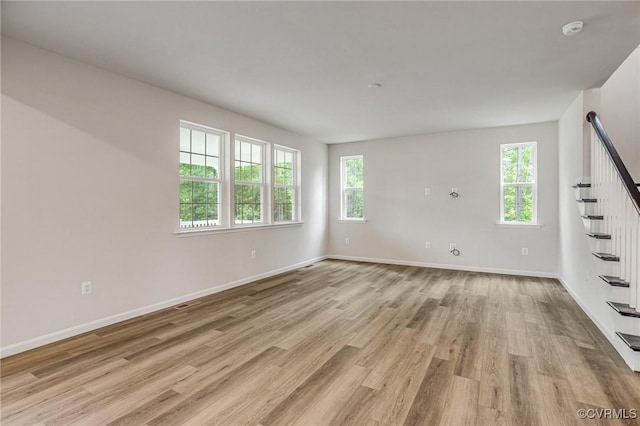 7127 Braxton Ct, Ladysmith, VA 22546 - spare room featuring stairway, light wood-style flooring, and a smoke detector