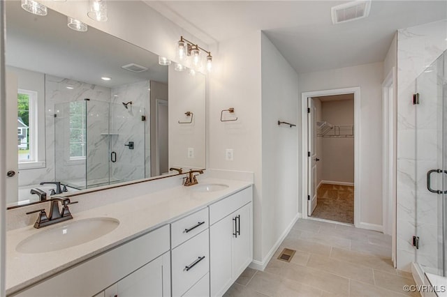 7127 Braxton Ct, Ladysmith, VA 22546 - full bath featuring double vanity, a marble finish shower, a spacious closet, and tile patterned flooring