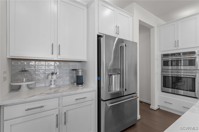 10109 Hollythorne Ln, Mechanicsville, VA 23116 - kitchen with stainless steel appliances, dark wood-style floors, white cabinetry, backsplash, and light stone counters