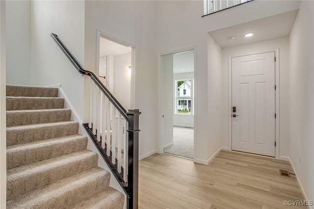 7107 Braxton Ct, Ladysmith, VA 22546 - foyer entrance with light wood-style flooring and stairs