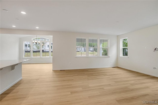 7107 Braxton Ct, Ladysmith, VA 22546 - empty room featuring a chandelier, plenty of natural light, light wood finished floors, and recessed lighting