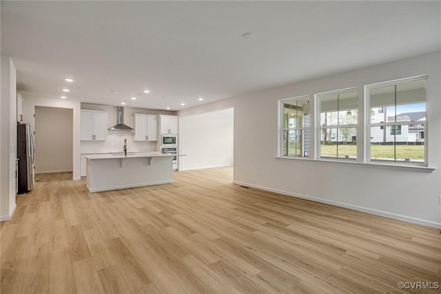 7107 Braxton Ct, Ladysmith, VA 22546 - unfurnished living room featuring light wood-type flooring and recessed lighting