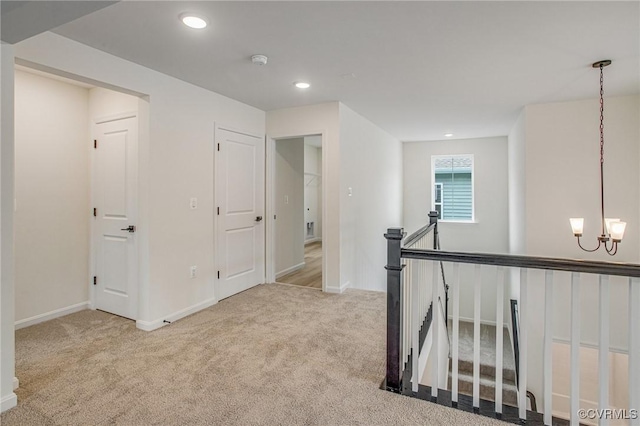 7107 Braxton Ct, Ladysmith, VA 22546 - hallway featuring carpet flooring, an upstairs landing, a chandelier, and recessed lighting