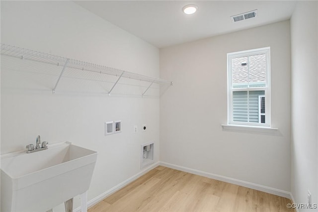 7107 Braxton Ct, Ladysmith, VA 22546 - laundry area featuring electric dryer hookup, light wood-style floors, and washer hookup