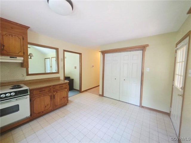 15805 Roland View Dr, Chesterfield, VA 23831 - kitchen featuring white electric range, under cabinet range hood, tasteful backsplash, light countertops, and brown cabinetry