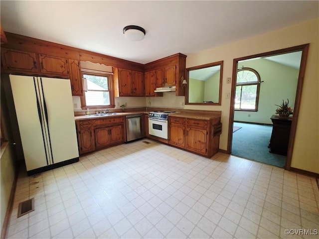 15805 Roland View Dr, Chesterfield, VA 23831 - kitchen with white appliances, under cabinet range hood, and brown cabinetry