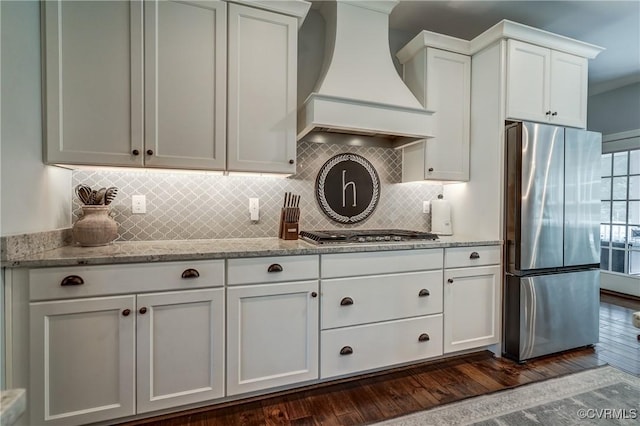 5025 Ellis Meadows Ct, Glen Allen, VA 23059 - kitchen with stainless steel appliances, custom range hood, backsplash, light stone counters, and white cabinetry