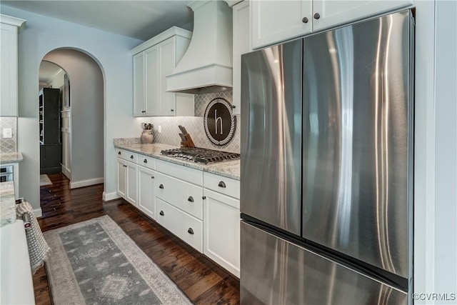 5025 Ellis Meadows Ct, Glen Allen, VA 23059 - kitchen with appliances with stainless steel finishes, custom exhaust hood, arched walkways, tasteful backsplash, and white cabinetry