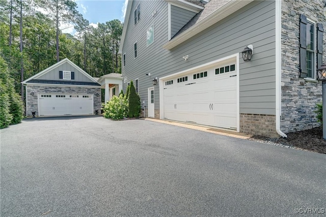 5025 Ellis Meadows Ct, Glen Allen, VA 23059 - view of side of property with stone siding and a garage