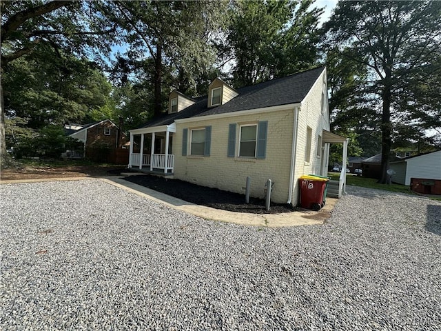 1883 Fairfax St, Petersburg, VA 23805 - view of front of property with brick siding, covered porch, and a shingled roof