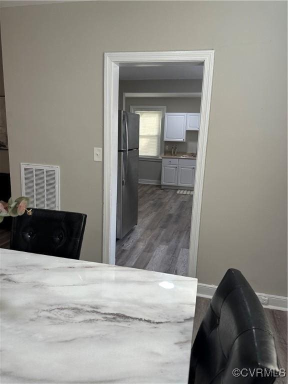 1883 Fairfax St, Petersburg, VA 23805 - bedroom with freestanding refrigerator and dark wood-style flooring