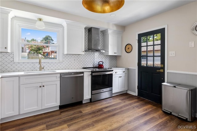 6213 Monument Ave, Richmond, VA 23226 - kitchen with appliances with stainless steel finishes, wall chimney range hood, light countertops, white cabinetry, and tasteful backsplash