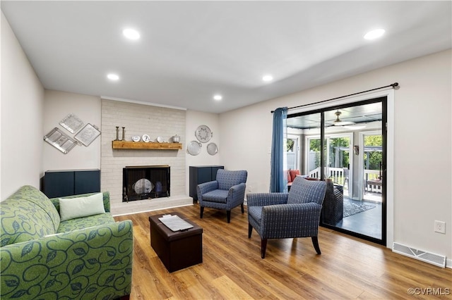 6213 Monument Ave, Richmond, VA 23226 - living room with wood finished floors, a fireplace, and recessed lighting