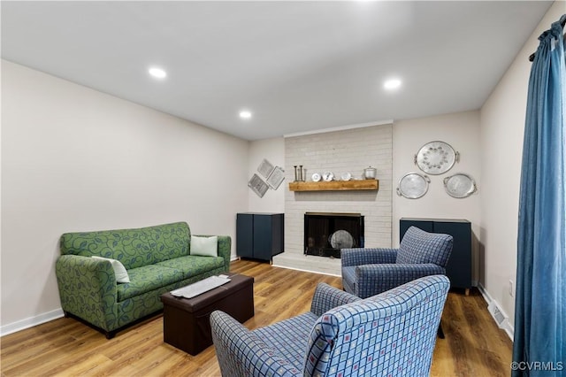 6213 Monument Ave, Richmond, VA 23226 - living area featuring wood finished floors, a brick fireplace, and recessed lighting