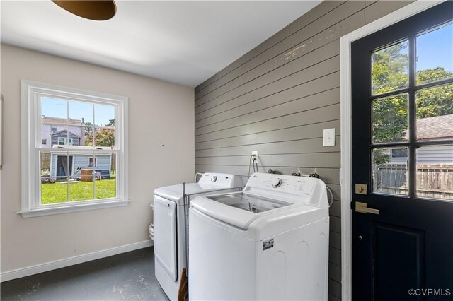 6213 Monument Ave, Richmond, VA 23226 - washroom with washer and clothes dryer, healthy amount of natural light, and wooden walls