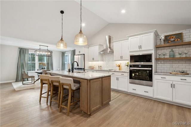 LOT47 Wendenburg Cir Lot 47, King William, VA 23009 - kitchen featuring wall chimney exhaust hood, freestanding refrigerator, white cabinets, light wood-style flooring, and backsplash