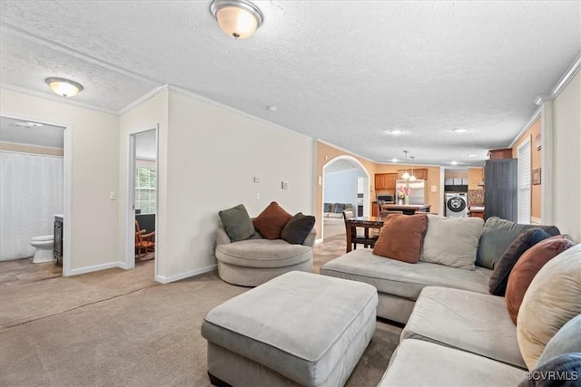 4627 Powhatan Lakes Rd Unit B, Powhatan, VA 23139 - living area with washer / clothes dryer, a textured ceiling, light colored carpet, crown molding, and arched walkways