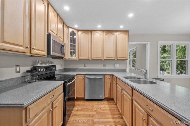 7906 Belmont Stakes Dr, Midlothian, VA 23112 - kitchen featuring appliances with stainless steel finishes, light brown cabinets, light wood finished floors, recessed lighting, and glass insert cabinets