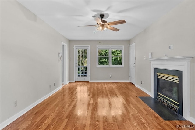 7906 Belmont Stakes Dr, Midlothian, VA 23112 - unfurnished living room featuring a ceiling fan, light wood-type flooring, and a fireplace with flush hearth