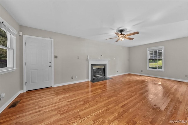 7906 Belmont Stakes Dr, Midlothian, VA 23112 - unfurnished living room with ceiling fan, light wood-style floors, and a fireplace with flush hearth