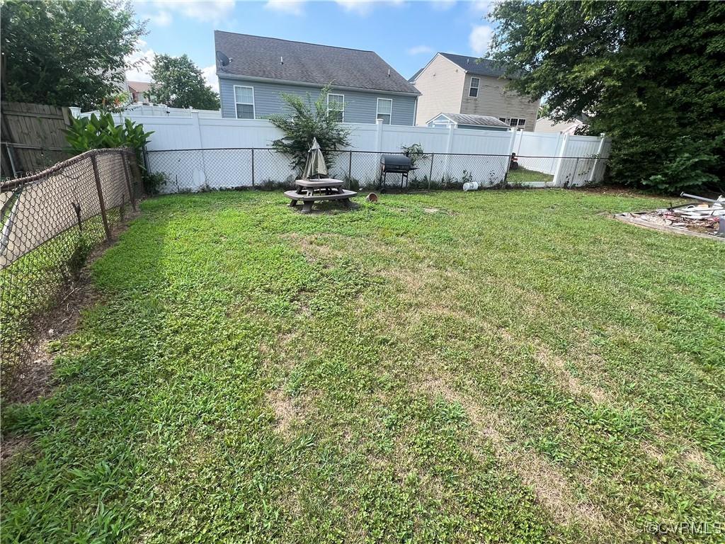 242 Bannon Ct, Hampton, VA 23666 - fenced backyard with an outdoor fire pit