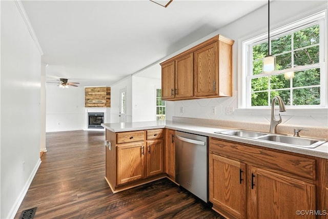 11918 Hazelnut Branch Ter, Midlothian, VA 23112 - kitchen with open floor plan, a large fireplace, stainless steel dishwasher, dark wood-style flooring, and brown cabinets