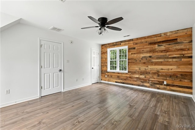11918 Hazelnut Branch Ter, Midlothian, VA 23112 - unfurnished living room with ceiling fan, wood walls, and wood finished floors