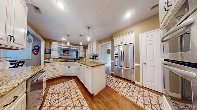 2024 Rockstone Pl, Henrico, VA 23238 - kitchen featuring appliances with stainless steel finishes, wood finished floors, recessed lighting, white cabinetry, and light stone countertops