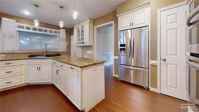 2024 Rockstone Pl, Henrico, VA 23238 - kitchen with appliances with stainless steel finishes, dark wood-style flooring, a peninsula, white cabinetry, and glass insert cabinets