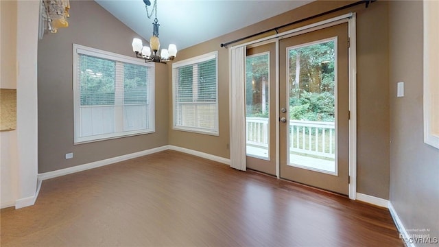 2024 Rockstone Pl, Henrico, VA 23238 - unfurnished dining area featuring a chandelier, vaulted ceiling, wood finished floors, and french doors