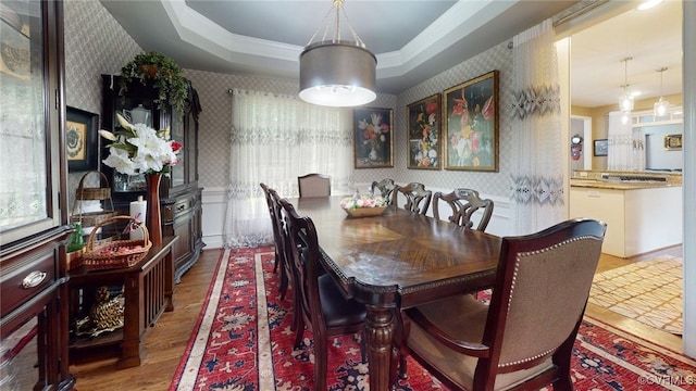 2024 Rockstone Pl, Henrico, VA 23238 - dining space featuring wallpapered walls, wood finished floors, a tray ceiling, and ornamental molding