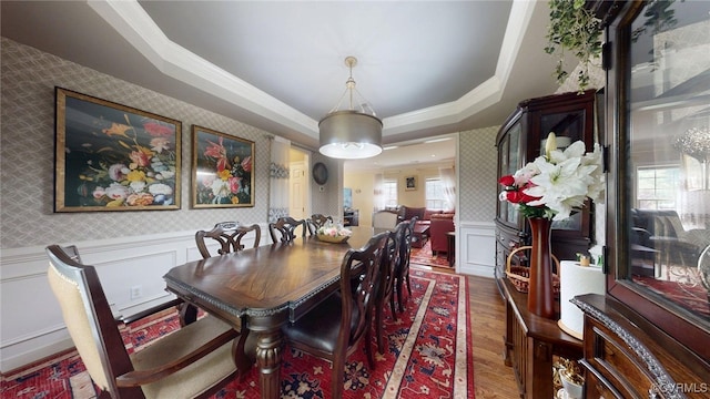 2024 Rockstone Pl, Henrico, VA 23238 - dining room featuring wood finished floors, a decorative wall, a tray ceiling, wainscoting, and ornamental molding
