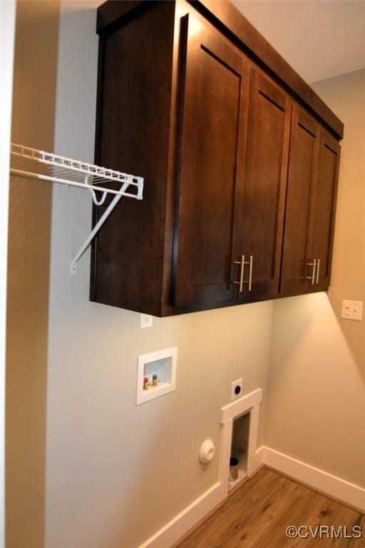 5102 Front Dr, North Dinwiddie, VA 23803 - washroom featuring cabinet space, electric dryer hookup, washer hookup, light wood-type flooring, and hookup for a gas dryer