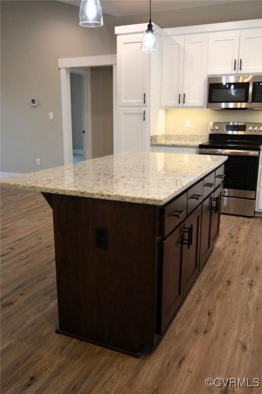 5102 Front Dr, North Dinwiddie, VA 23803 - kitchen with stainless steel appliances, a center island, white cabinetry, and wood finished floors