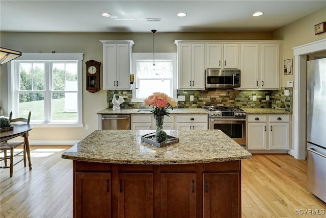 7413 Settlers Ridge Ct, Henrico, VA 23231 - kitchen with appliances with stainless steel finishes, light wood finished floors, white cabinets, backsplash, and recessed lighting