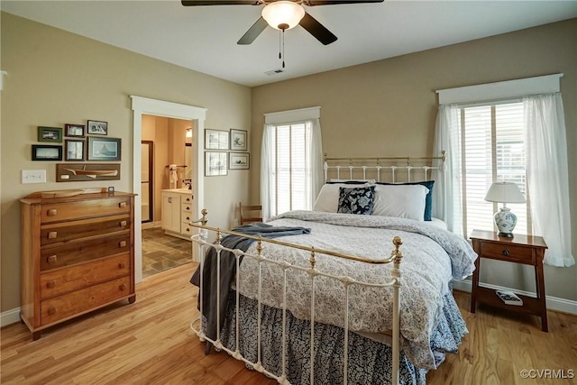 7413 Settlers Ridge Ct, Henrico, VA 23231 - bedroom featuring multiple windows, light wood-style floors, connected bathroom, and a ceiling fan